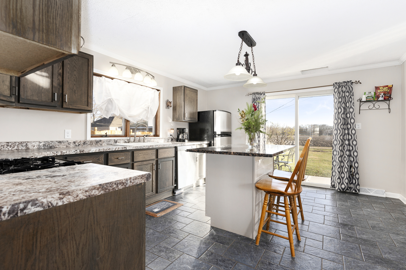 402 Center Street Mazon, IL 60444 - Photo 4 of 15 a kitchen with stainless steel appliances kitchen island granite countertop a table chairs in it and wooden floors