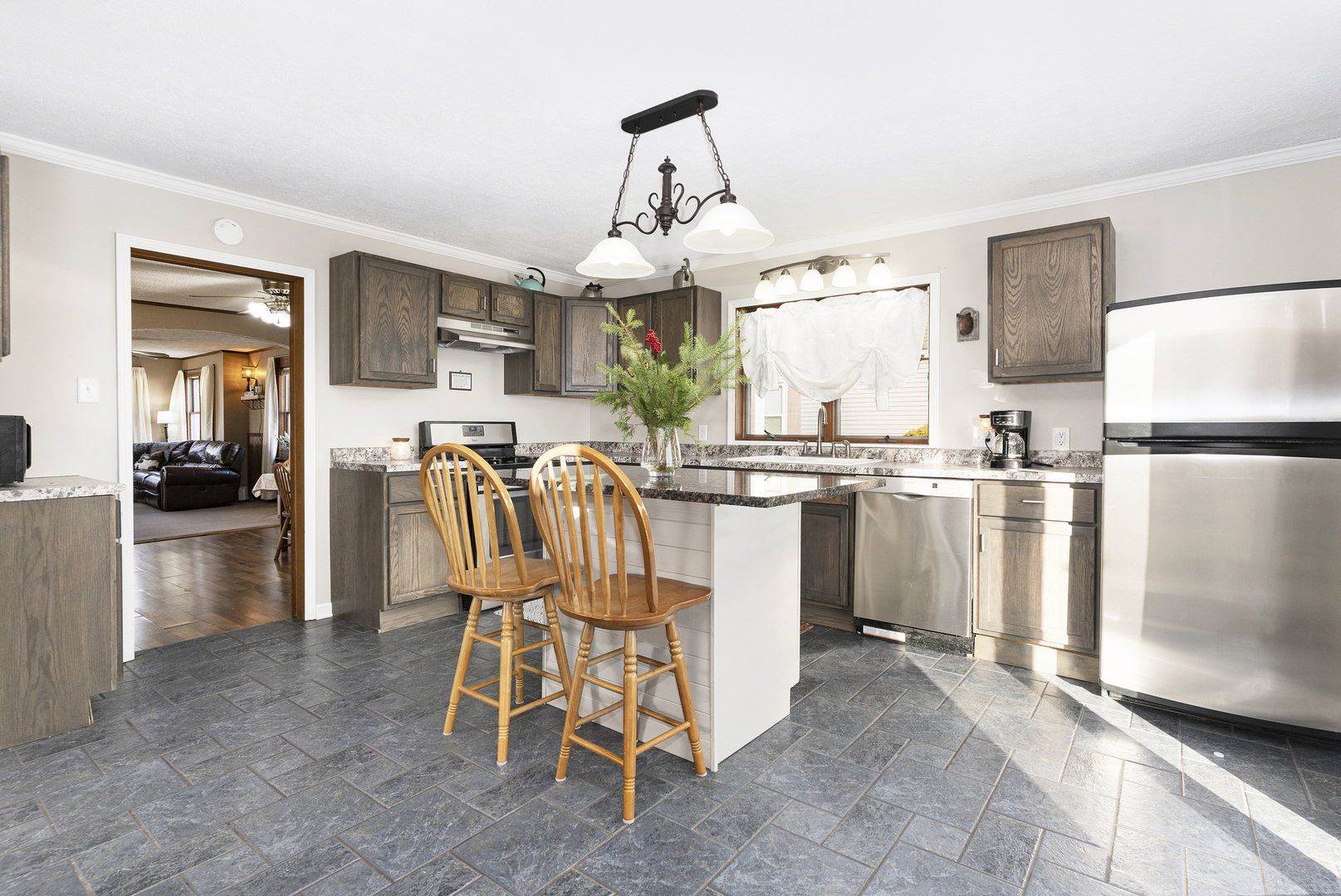 402 Center Street Mazon, IL 60444 - Photo 5 of 15 a dining room with stainless steel appliances kitchen island granite countertop a refrigerator a sink dishwasher a dining table and chairs with wooden floor