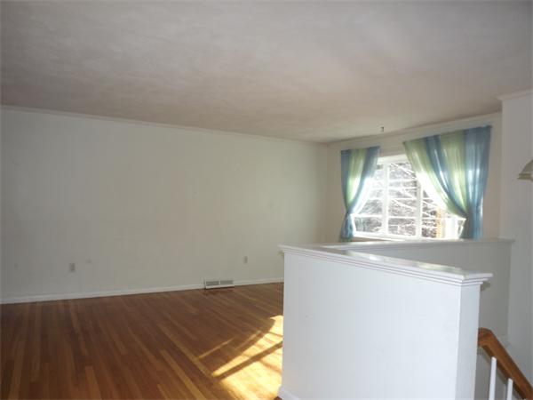90 Holly Road Marshfield, MA 02050 - Photo 3 of 17 an empty room with wooden floor and windows
