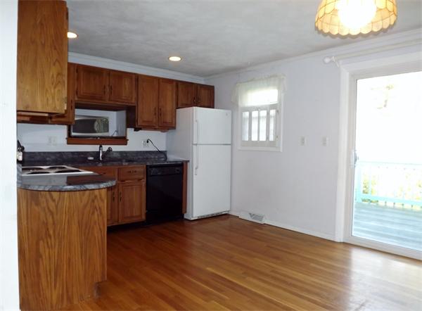 90 Holly Road Marshfield, MA 02050 - Photo 4 of 17 a kitchen with granite countertop wooden floors a stove and a refrigerator