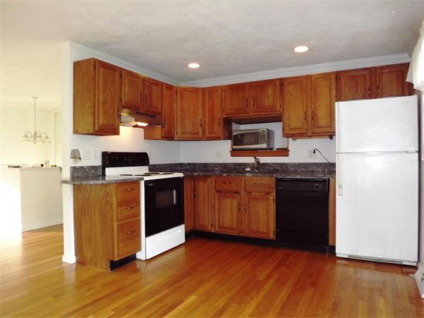 90 Holly Road Marshfield, MA 02050 - Photo 5 of 17 a kitchen with granite countertop wooden floors a stove and a refrigerator