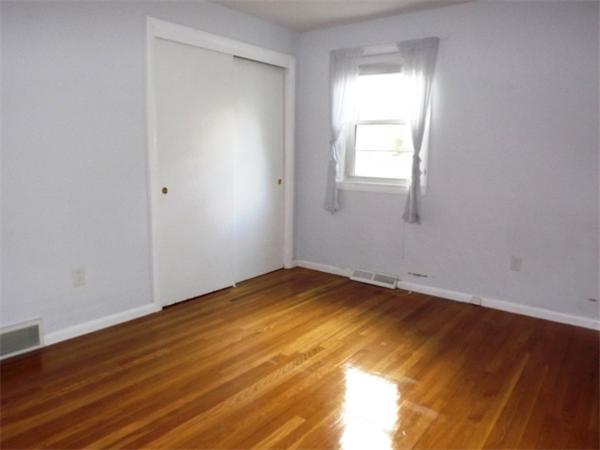 90 Holly Road Marshfield, MA 02050 - Photo 6 of 17 a view of empty room with wooden floor and fan