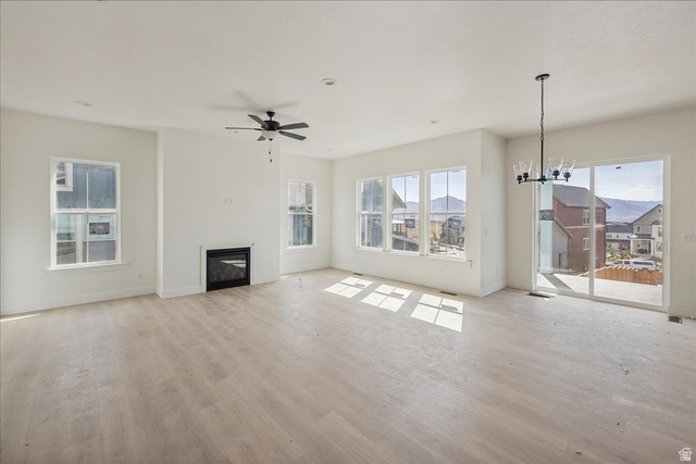 7189 South Sage Road, Unit 214 West Jordan, UT 84081 - Photo 9 of 29 Spacious living area featuring light wood-finish flooring, a modern electric fireplace, and multiple windows