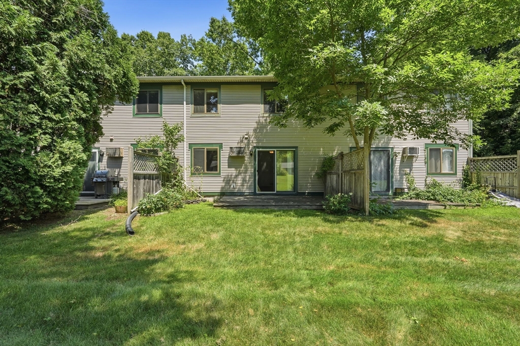 170 East Hadley Road, Unit 96 Amherst, MA 01002 - Photo 29 of 36 a white house that has a small yard and large trees