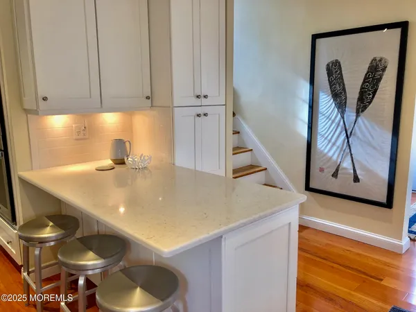 a kitchen with a sink a stove and cabinets