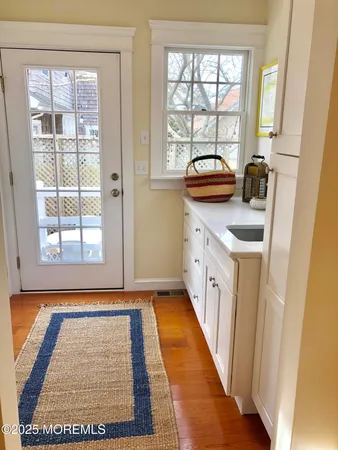a bathroom with a granite countertop sink and a window