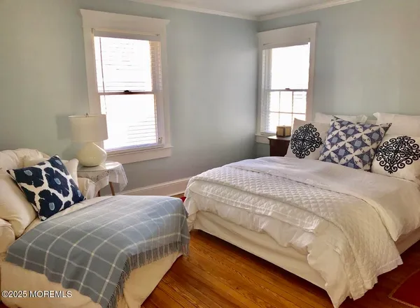 a bedroom with two beds and a window