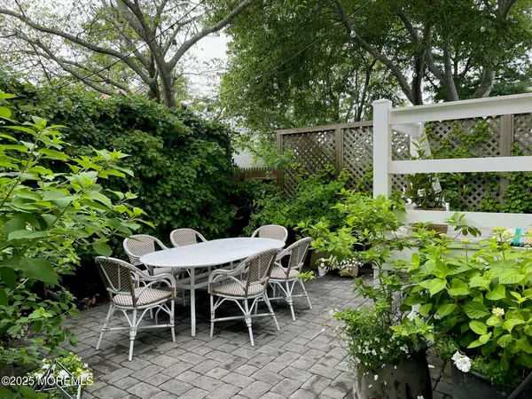 a view of a backyard with furniture and garden