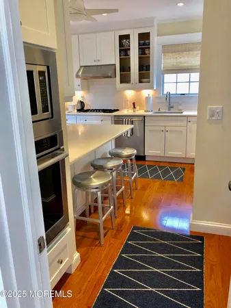 a kitchen with stainless steel appliances a stove a sink and a refrigerator