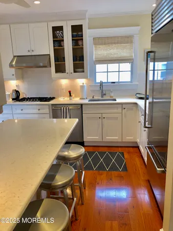 a kitchen with a sink appliances and cabinets