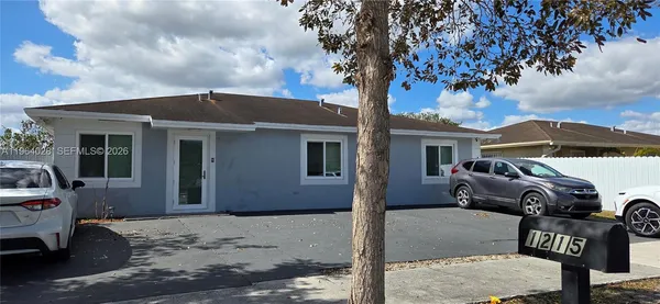 a front view of a house with parking area