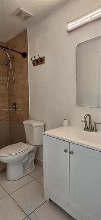 a bathroom with a toilet sink and shower