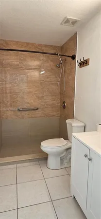 a bathroom with a toilet sink and shower