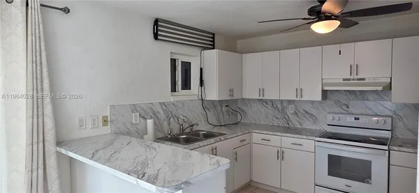 a kitchen with a stove cabinets and a sink