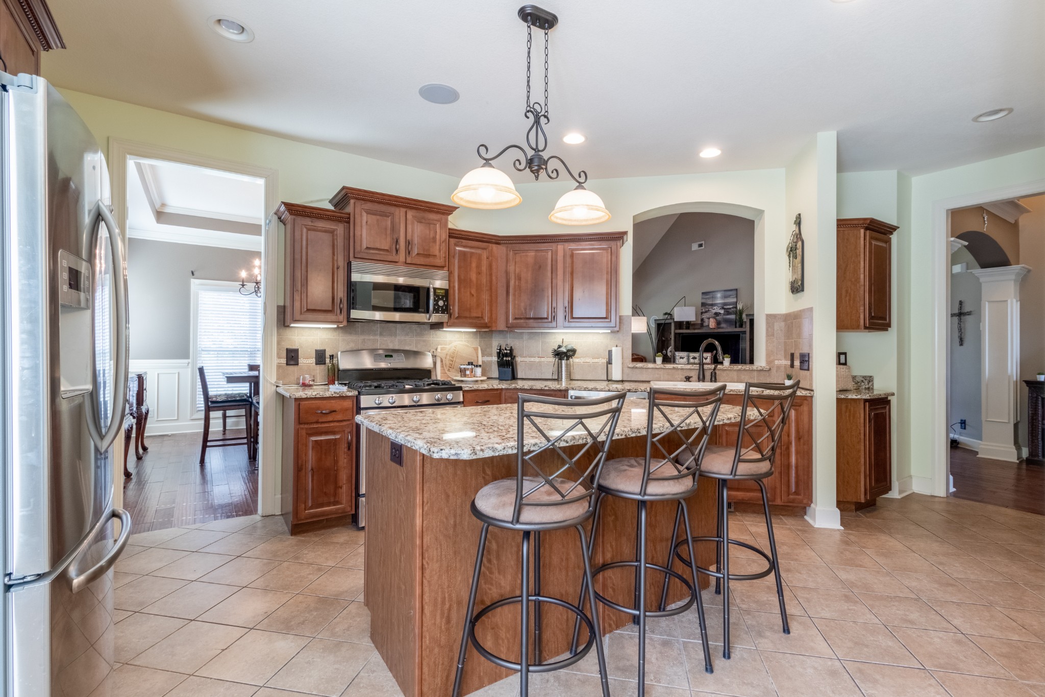 3592 Drake Road Adams, TN 37010 - Photo 15 of 47 a kitchen with stainless steel appliances granite countertop a stove a refrigerator a oven a sink a dining table and chairs
