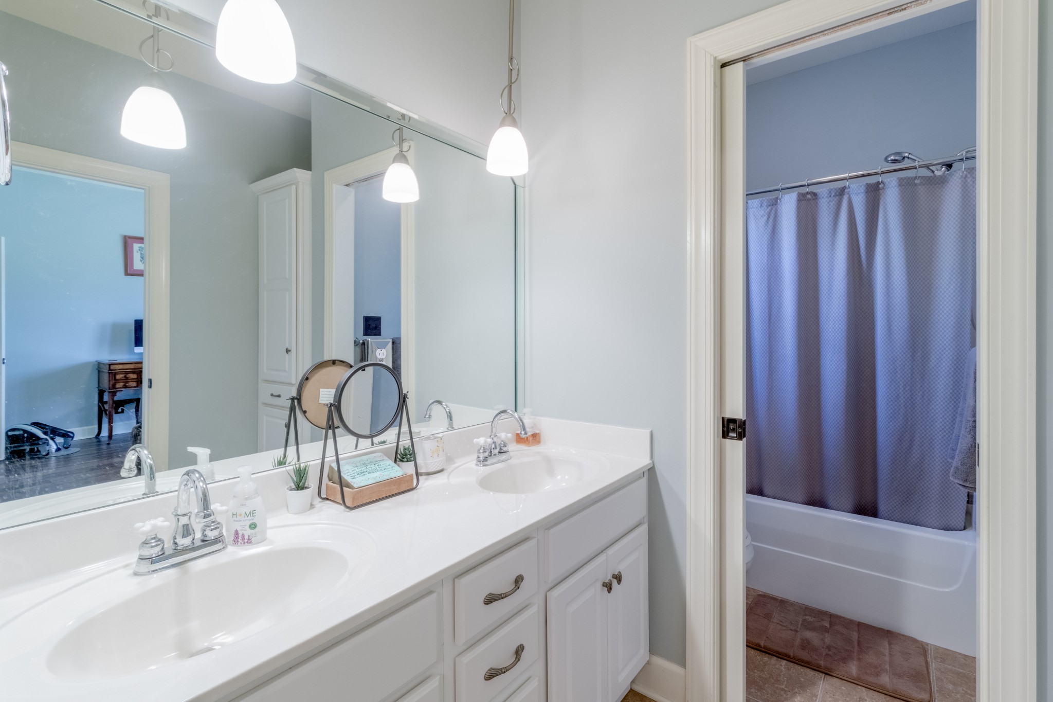 3592 Drake Road Adams, TN 37010 - Photo 26 of 47 a bathroom with a double vanity sink and a mirror