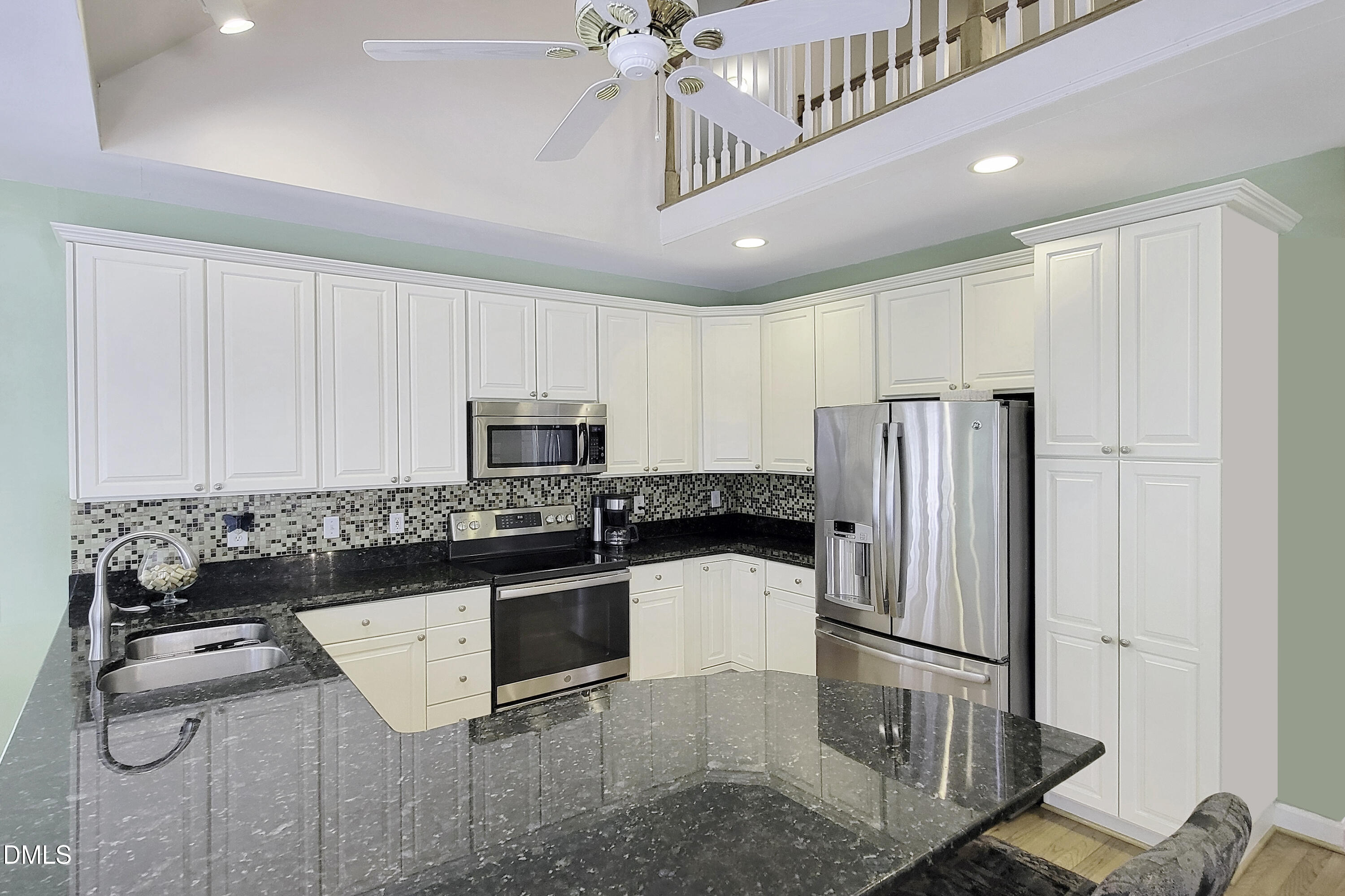 101 Sandy Hook Way Cary, NC 27513 - Photo 22 of 40 a kitchen with stainless steel appliances granite countertop a refrigerator sink stove and microwave