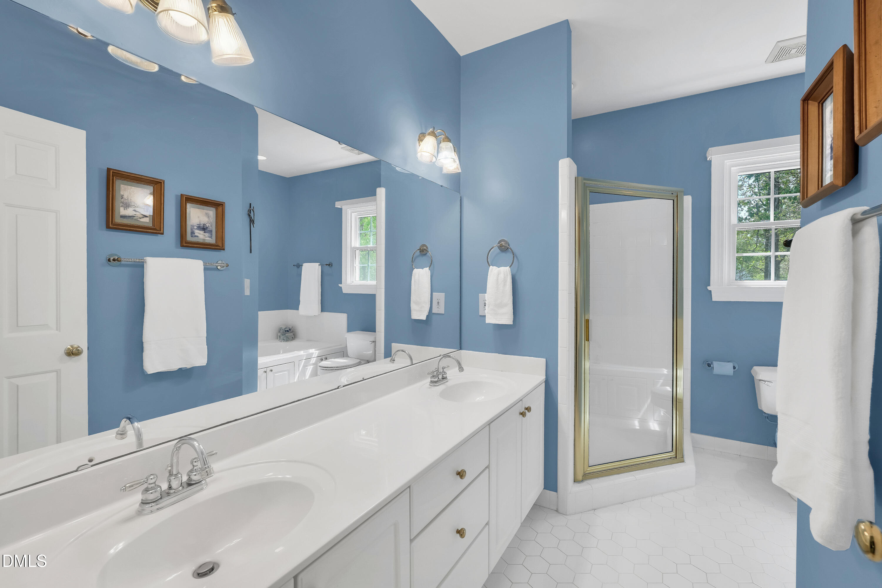 101 Sandy Hook Way Cary, NC 27513 - Photo 30 of 40 a spacious bathroom with a double vanity sink and a mirror
