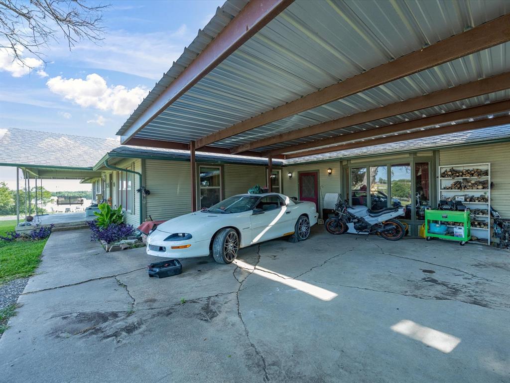 301 Ovilla Road Waxahachie, TX 75167 - Photo 34 of 38 a view of a garage and a car parked in garage