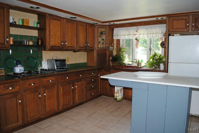 1209 Clearfield Road Nazareth, PA 18064 - Photo 16 of 22 a kitchen with stainless steel appliances granite countertop a sink counter space and a large window