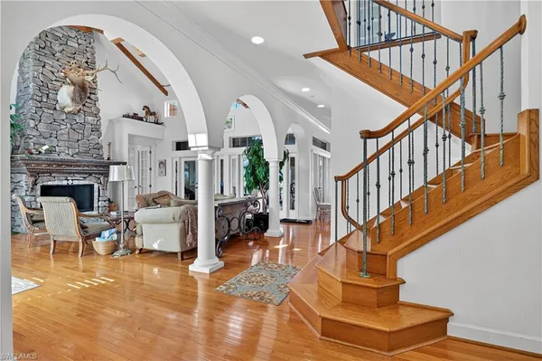 a view of entryway livingroom and hall with wooden floor