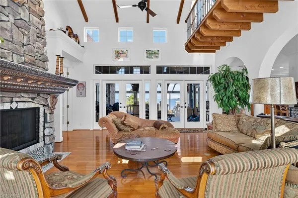 a living room with furniture a fireplace and a flat screen tv