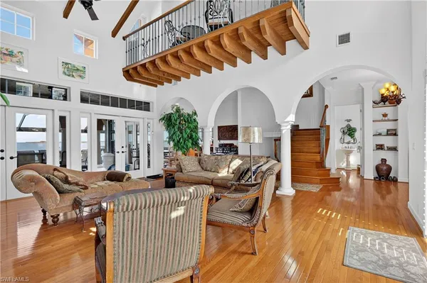 a living room with fireplace furniture and a rug
