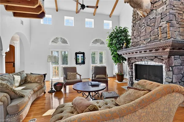 a living room with furniture kitchen view and a fireplace