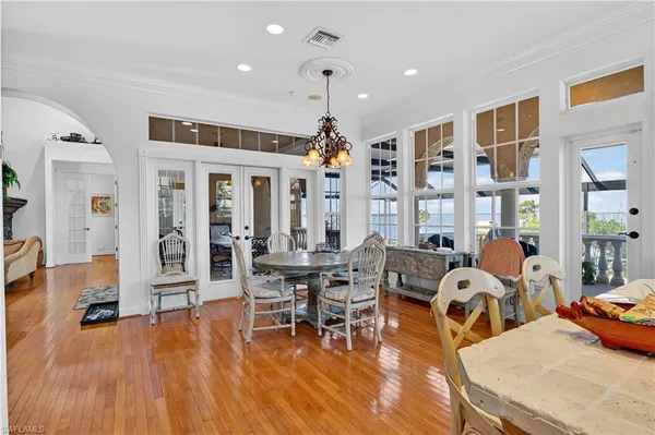 a living room with furniture large window and wooden floor
