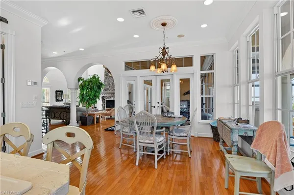 a view of a dining room with furniture chandelier and wooden floor