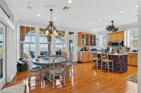 a view of a dining room with furniture and chandelier