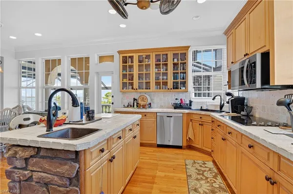 a kitchen with stainless steel appliances granite countertop a sink stove and cabinets