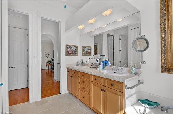 a spacious bathroom with a double vanity sink mirror and shower
