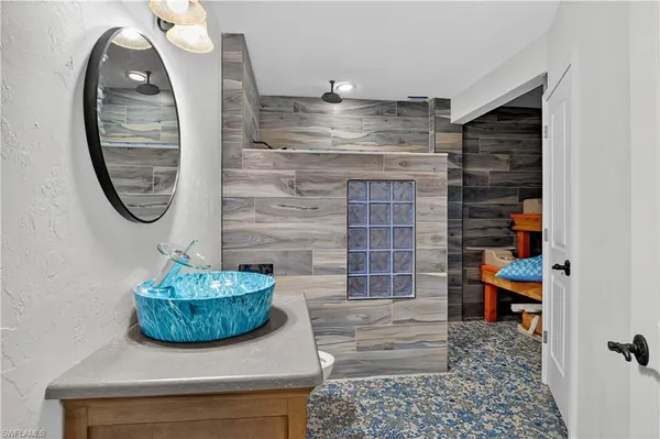 a view of bathroom with a sink and a mirror
