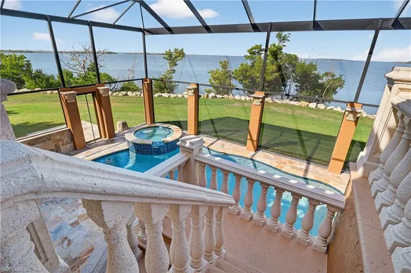 a view of balcony with chairs and umbrella