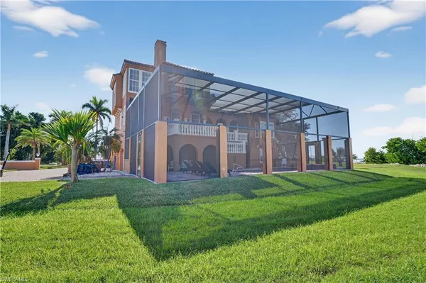 a view of a house with a big yard and potted plants