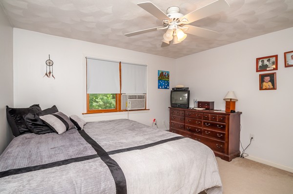 14 Carroll Road Woburn, MA 01801 - Photo 25 of 30 a bedroom with a bed and a chandelier