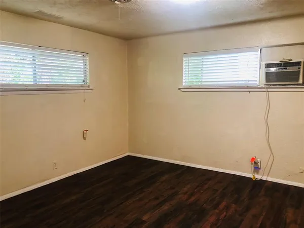 a view of a room with wooden floor and window