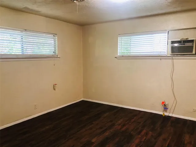 a view of a room with wooden floor and window