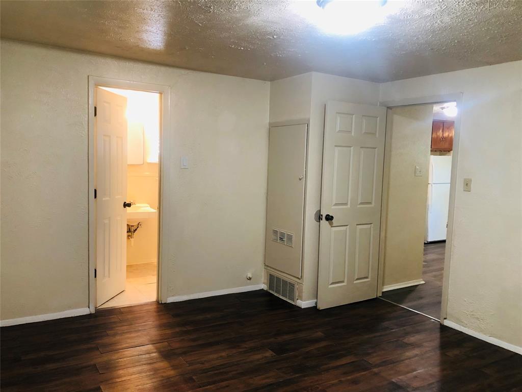 518 West Sycamore Street Denton, TX 76201 - Photo 8 of 11 a view of an empty room with wooden floor and a window