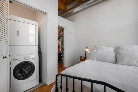 a bedroom with a bed and a chair