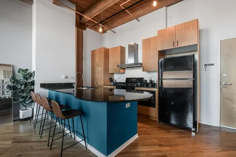 a kitchen with refrigerator and cabinets