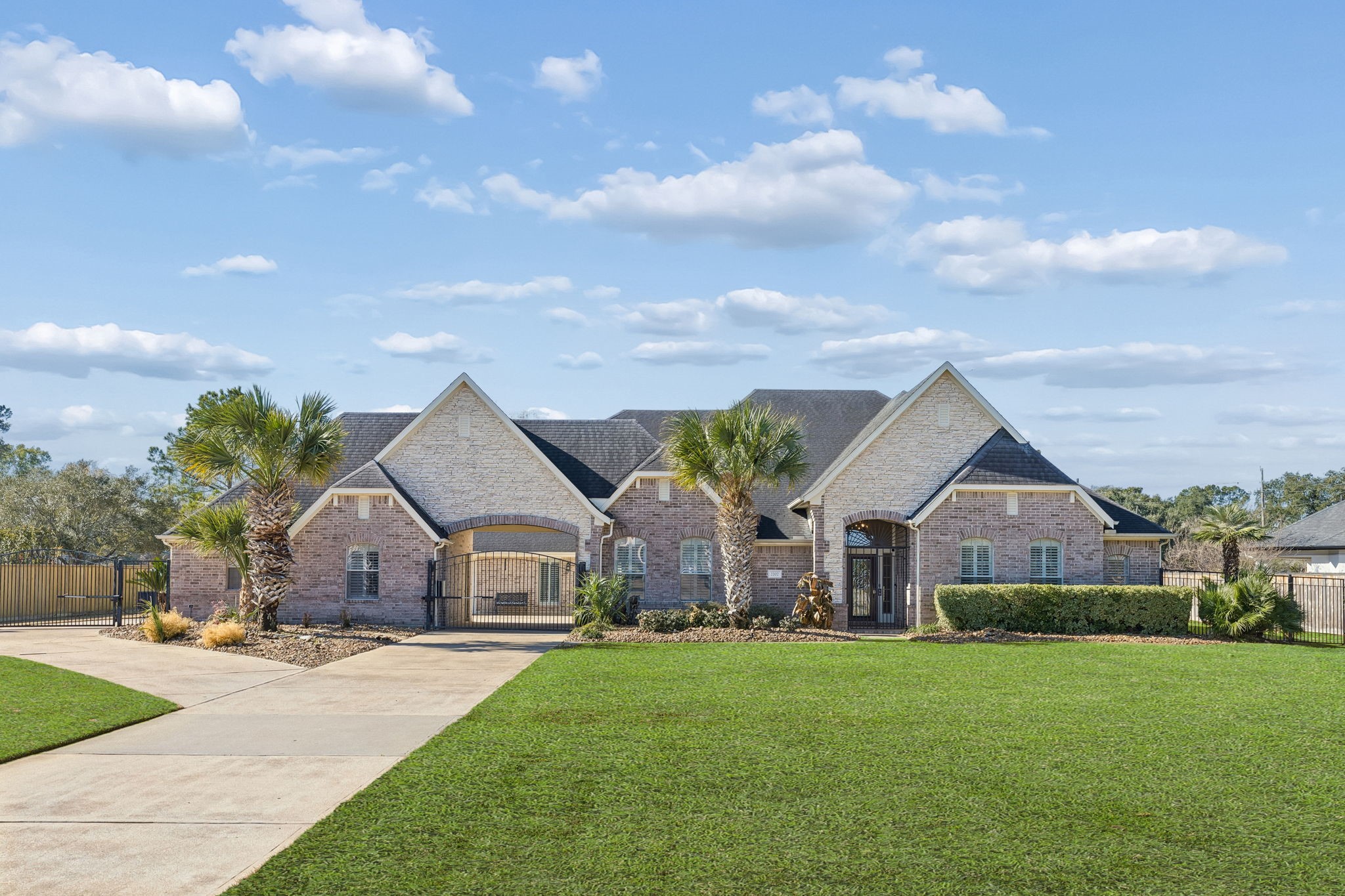 Set on nearly a full acre in the private, guard-gated Lake Pointe Estates community, this custom estate at 2202 Britton Ridge Drive offers striking curb appeal, a gated motor court, and a rare 4-car garage in one of Katy, Texas’ most exclusive neighborhoods. Zoned to A-rated Tompkins High School with a low tax rate and no MUD tax, this home delivers luxury, privacy, and location at the highest level.