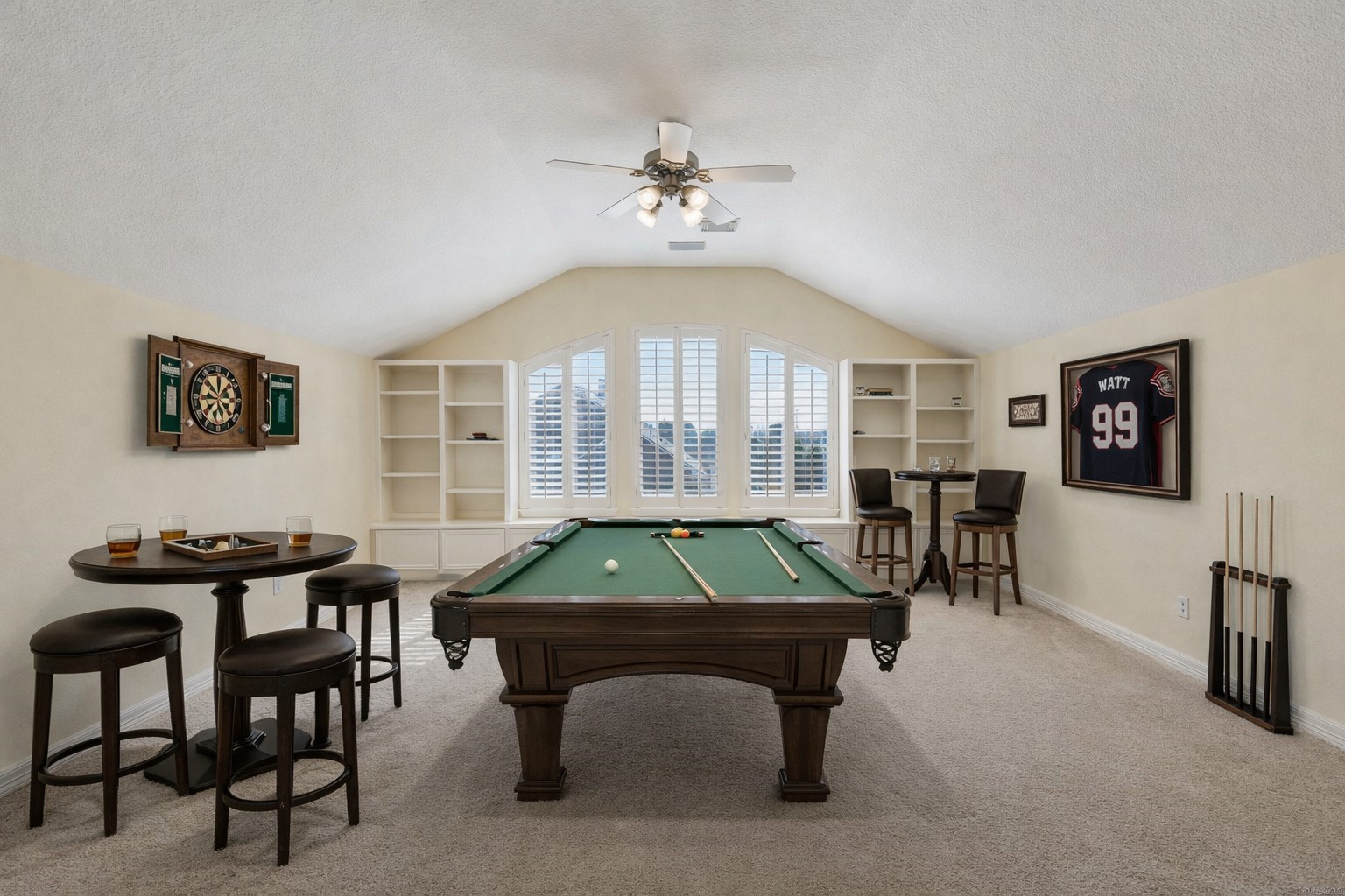 2202 Britton Ridge Drive Katy, TX 77494 - Photo 21 of 41 Spacious upstairs game room wired for sound, featuring vaulted ceilings, built-in shelving, and ample space for a full-size billiards table—an ideal setting for game nights, a media lounge, or an elevated entertainment retreat.
