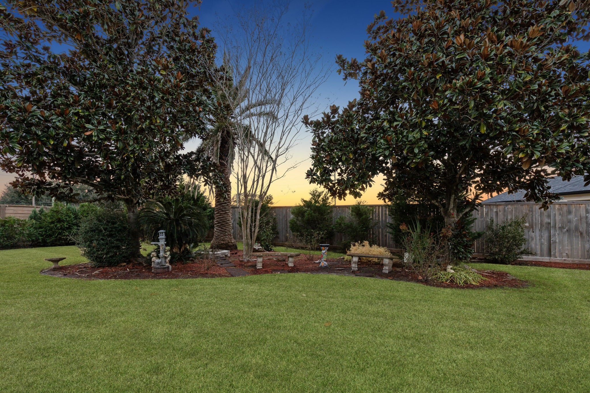 2202 Britton Ridge Drive Katy, TX 77494 - Photo 33 of 41 Expansive, park-like backyard with mature trees and lush landscaping—offering plenty of open green space for play, pets, or future additions, all set on a nearly one-acre lot within the private, guard-gated Lake Pointe Estates community.