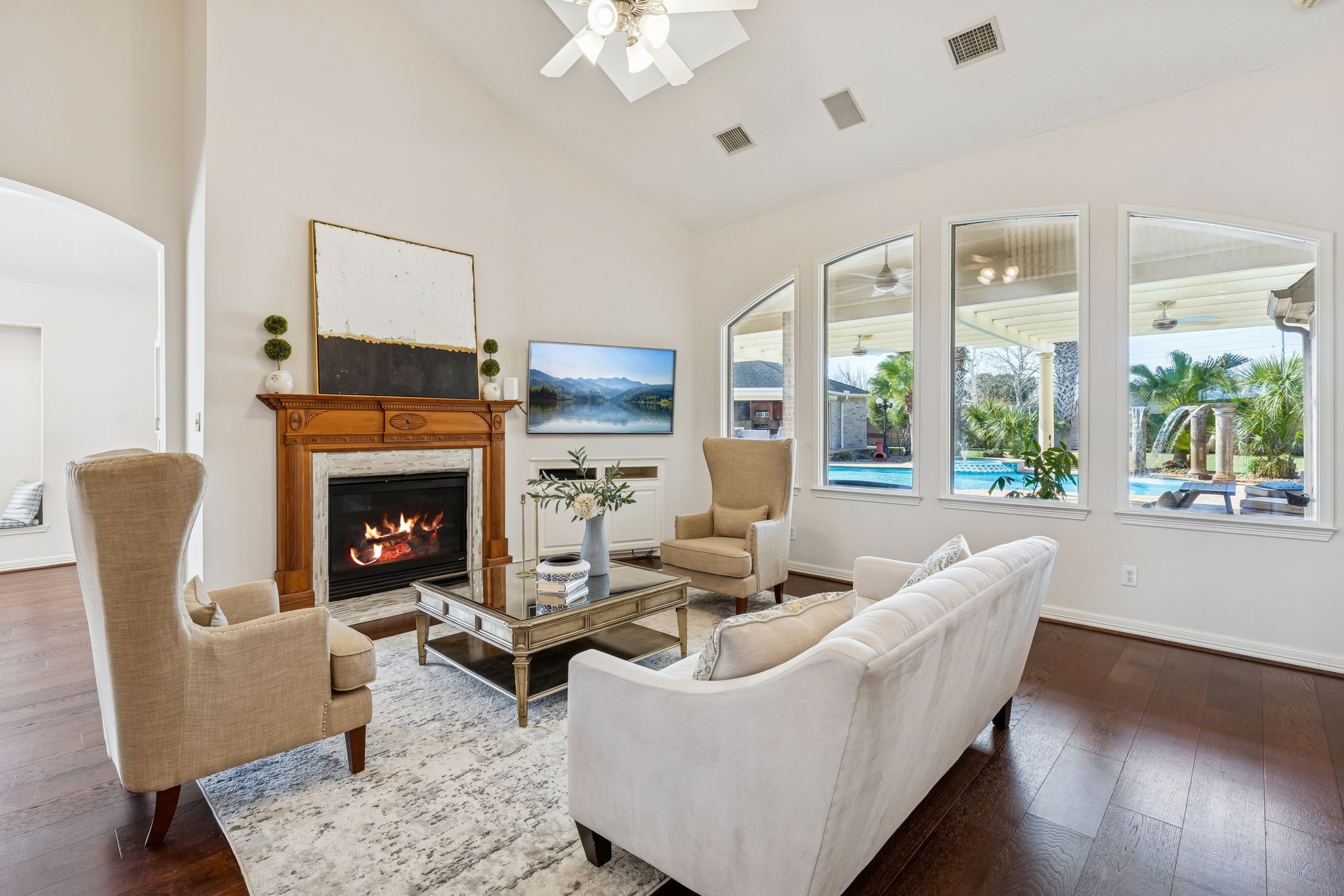 2202 Britton Ridge Drive Katy, TX 77494 - Photo 6 of 41 This inviting living room features large windows with stunning views of the private pool. The space is centered by a classic wood-mantle fireplace and highlighted by vaulted ceilings.
