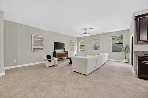 a bedroom with a large bed couch and a window
