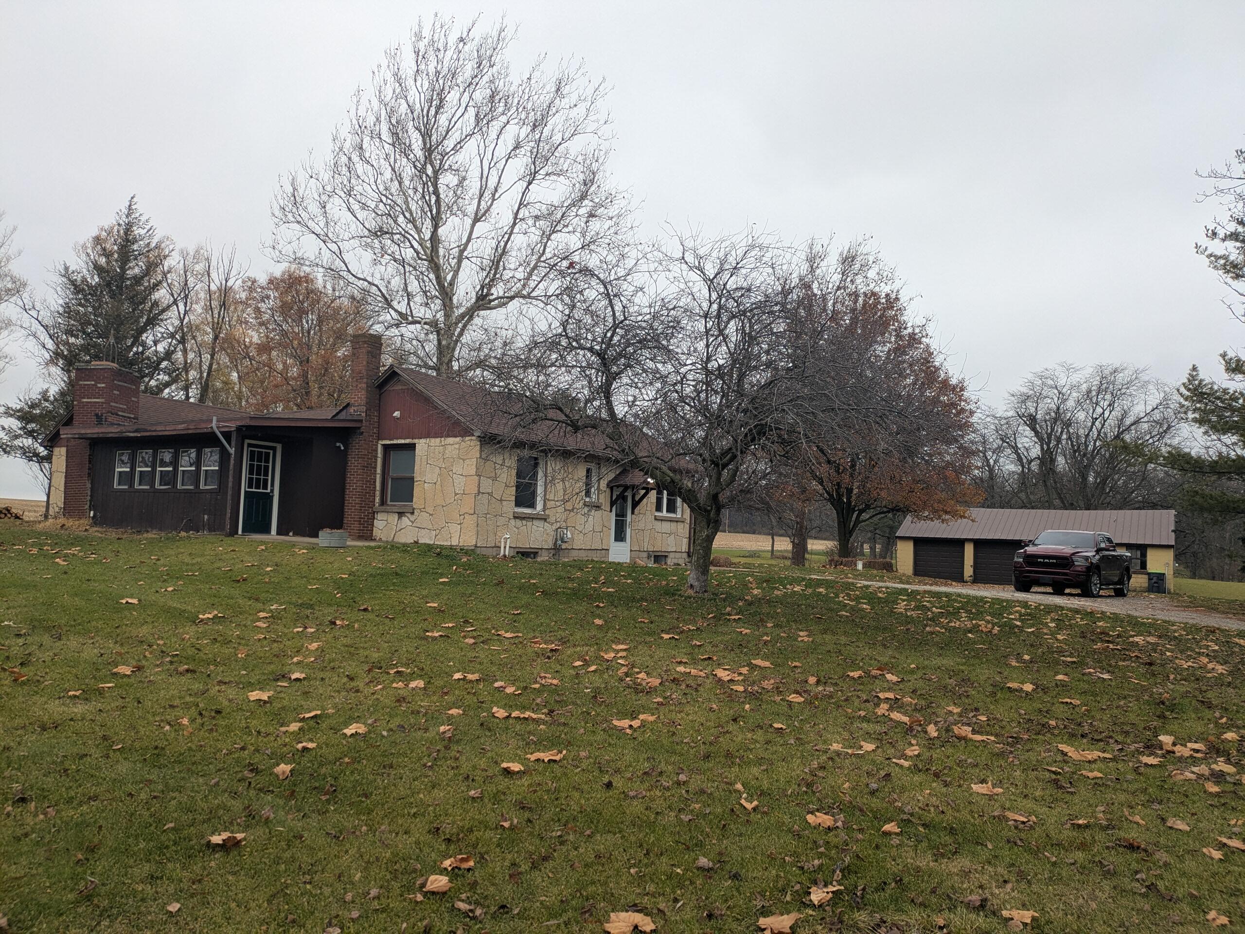 a view of a yard in front of a house with large tree