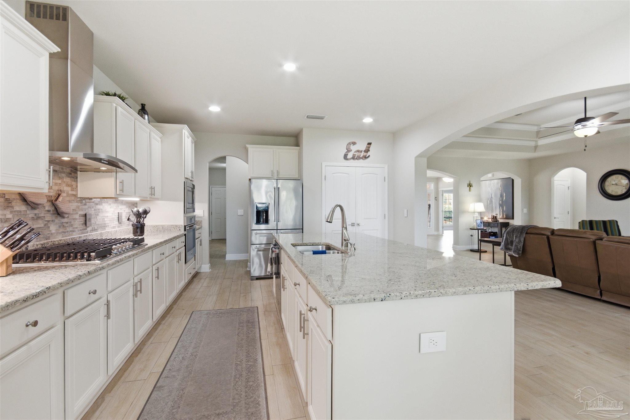 2677 Tulip Hill Road Pace, FL 32571 - Photo 14 of 35 a large kitchen with kitchen island a sink and white cabinets