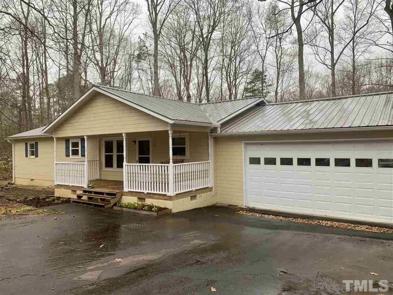 816 Patrick Road Bahama, NC 27503 - Photo 2 of 20 a front view of a house with a yard